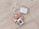A set of pearl hair clips, a bar of natural handcrafted soap, and a beige satin scrunchie arranged on a light wood surface. The soap is labeled with 'JONK' and mentions scents of guido and eucalyptus.
