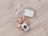 A set of pearl hair clips, a bar of natural handcrafted soap, and a beige satin scrunchie arranged on a light wood surface. The soap is labeled with 'JONK' and mentions scents of guido and eucalyptus.