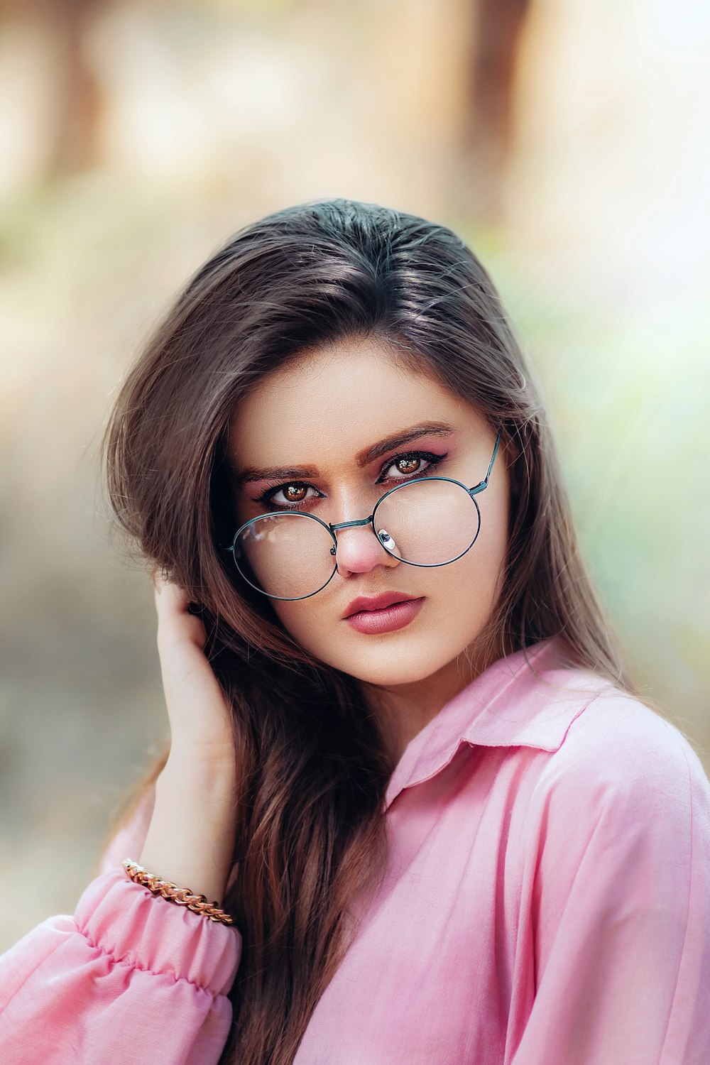 girl in pink shirt wearing black framed eyeglasses