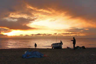 silhouette of people on beach during sunset