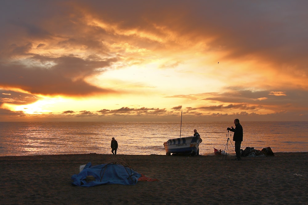 silhouette of people on beach during sunset