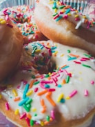 A close-up of freshly made mini donuts with sprinkles.