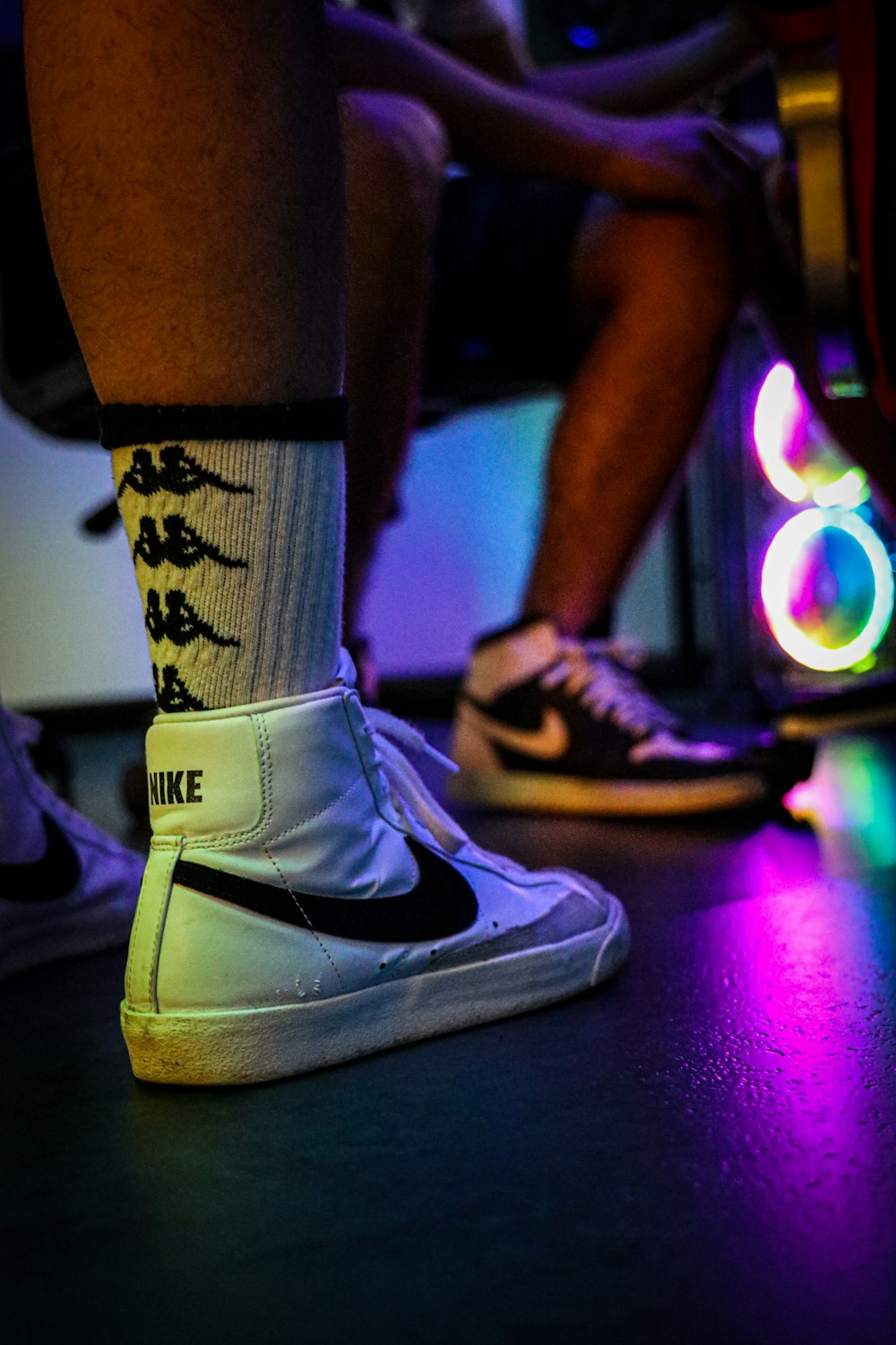 person wearing black and white nike sneakers