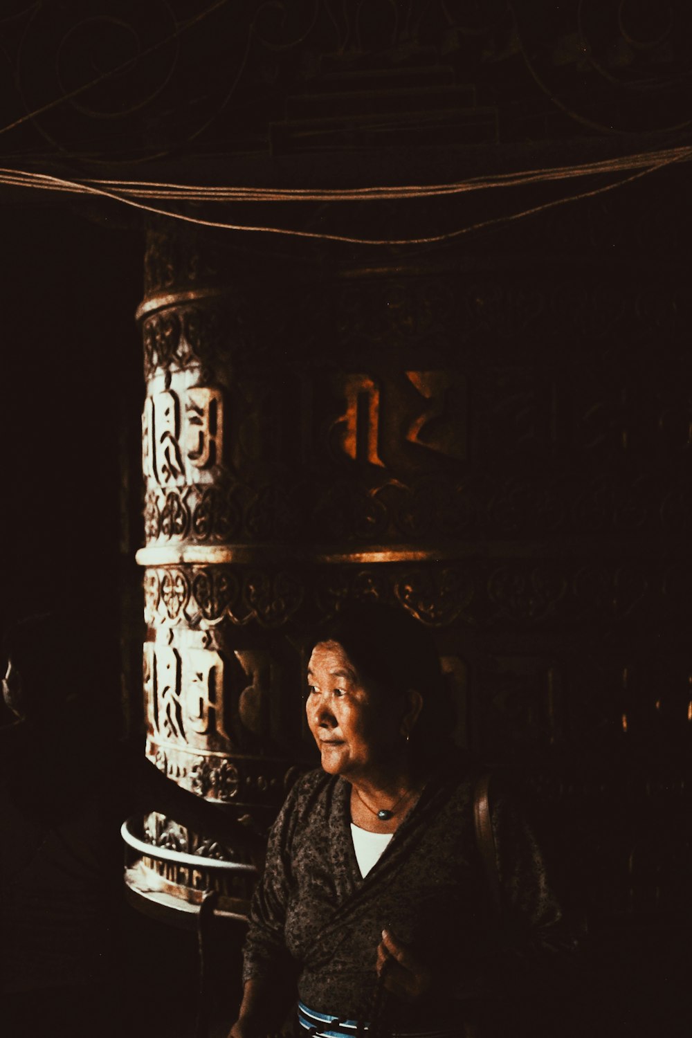 a woman standing in front of a tall pillar