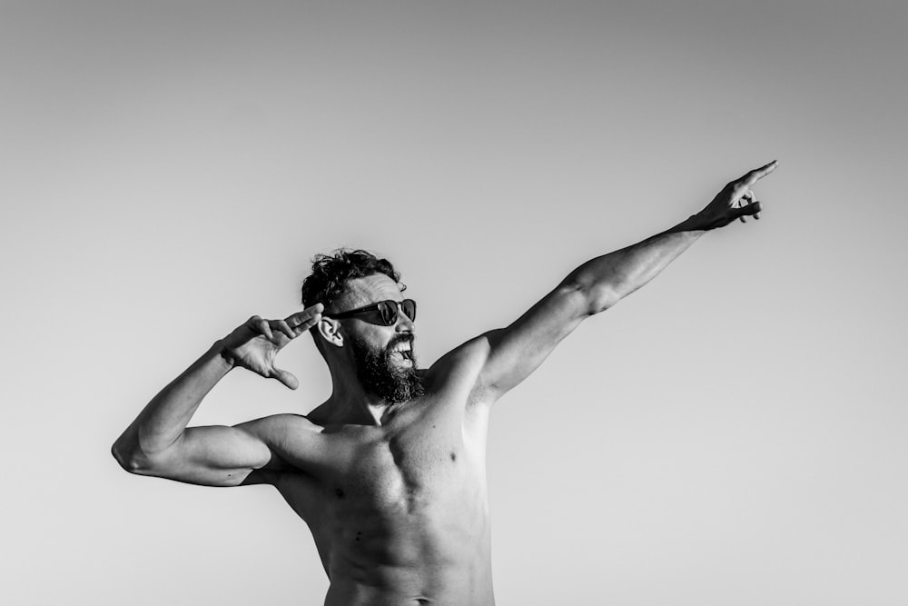 grayscale photo of topless man wearing sunglasses