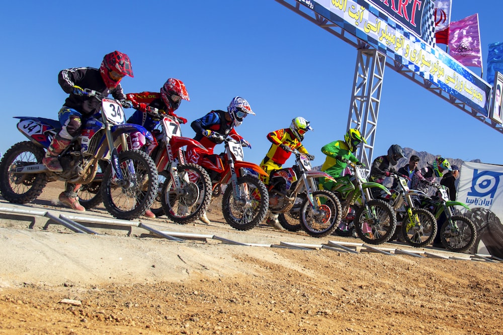 people riding motocross dirt bikes during daytime