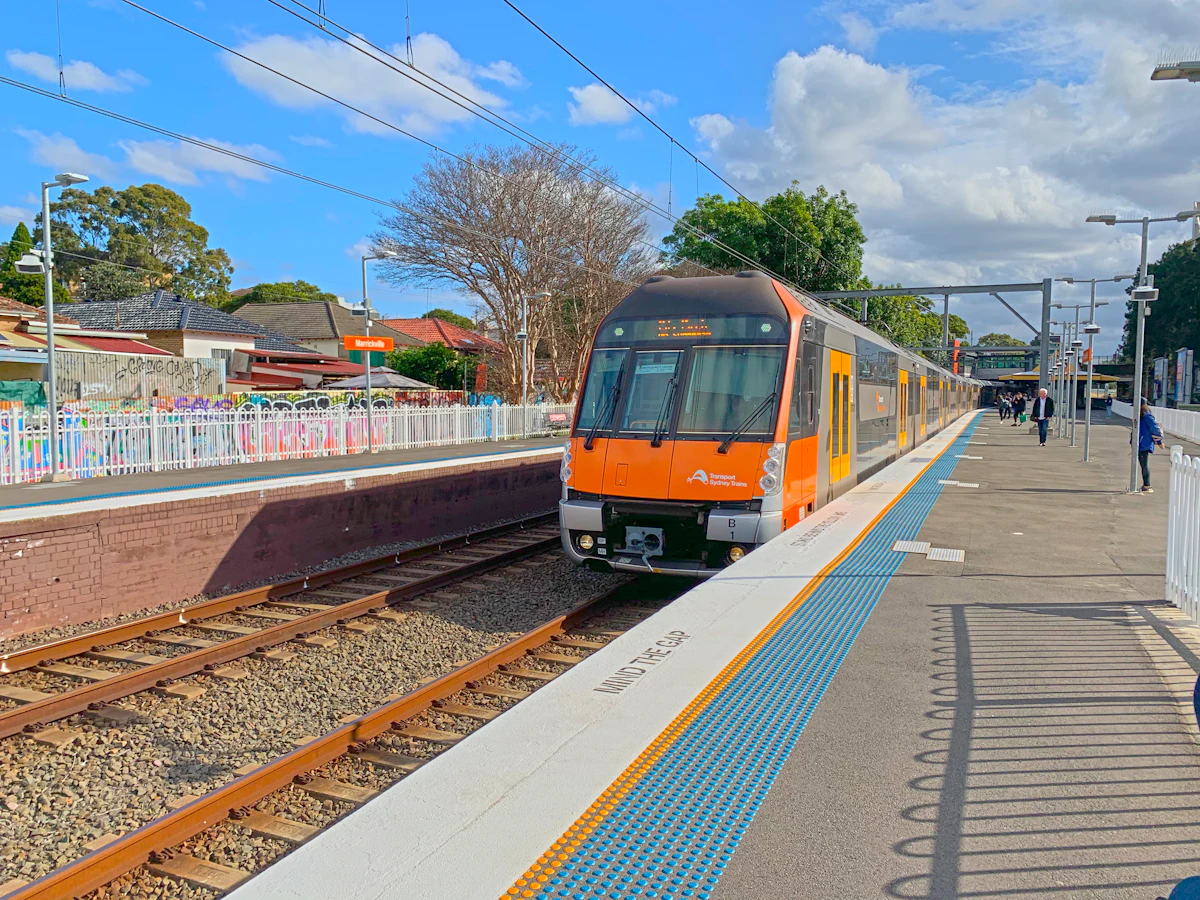 Sydney passenger train arriving at a suburban station