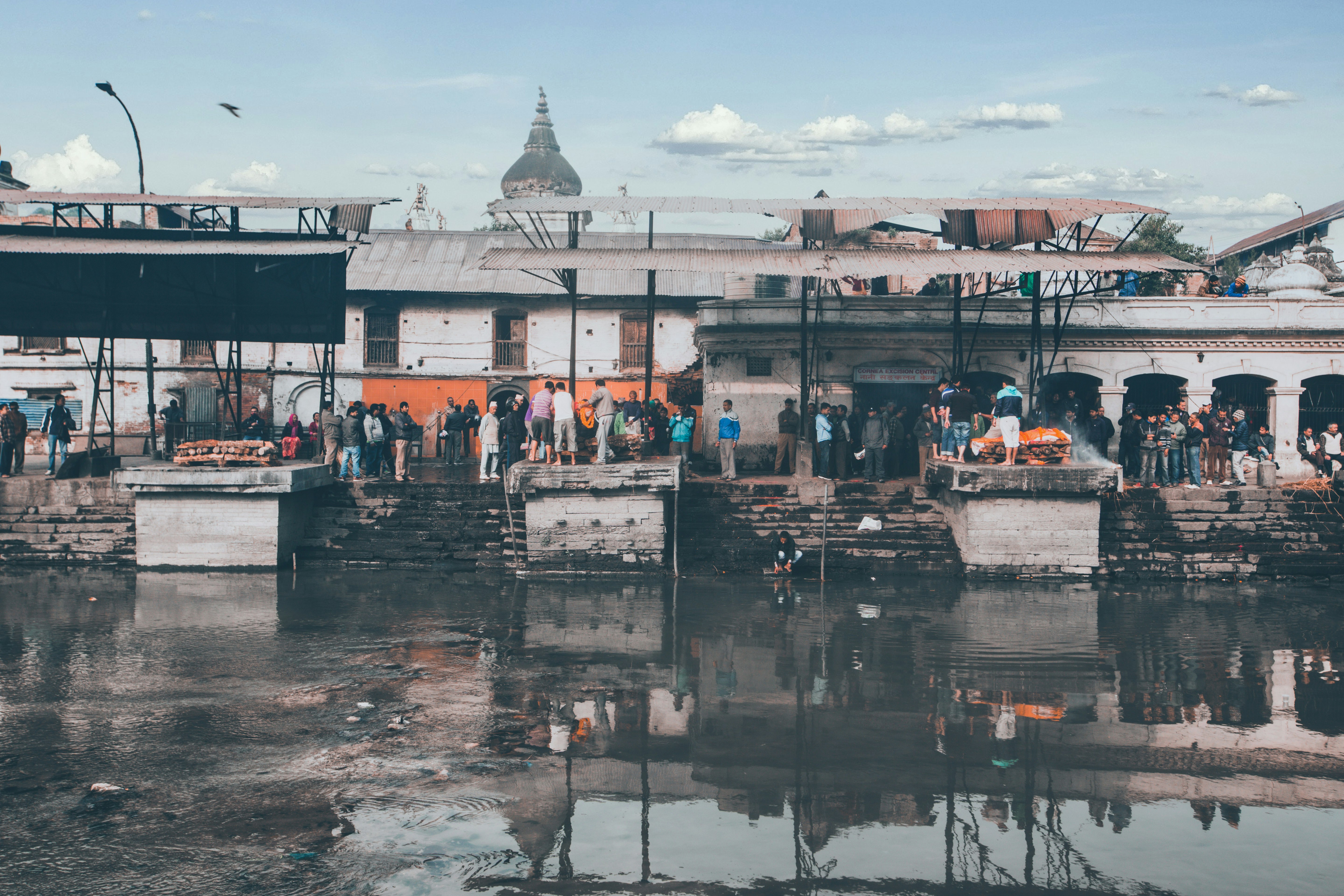 people walking on dock near white concrete building during daytime