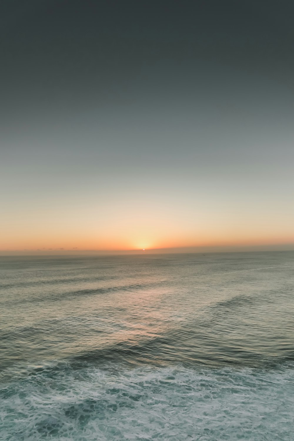 body of water during sunset