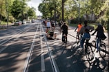 A group of diverse cyclists smiling and riding together on a sunny trail.