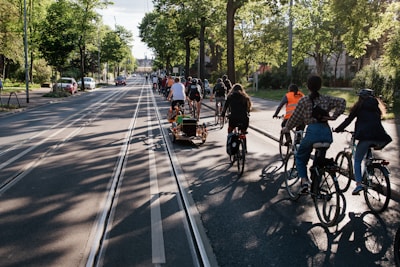 A group of diverse cyclists smiling and riding together on a sunny trail.