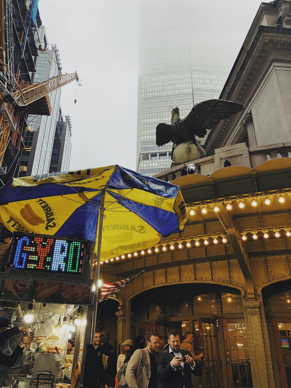 yellow and green umbrella near building during daytime