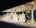 man in yellow jacket standing near gas pump