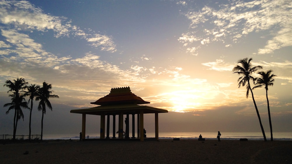 silhouette of people on beach during sunset