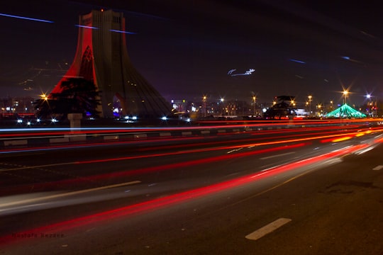 cars on road during night time in Azadi Square Iran