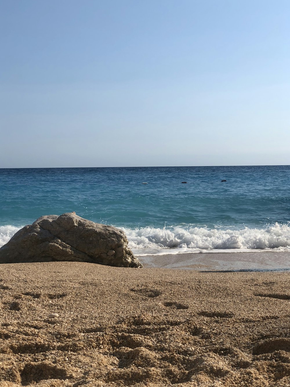 brown rock formation on sea shore during daytime