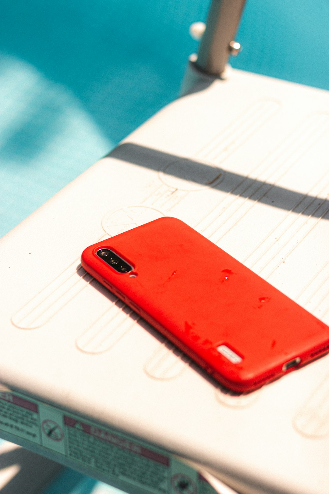 red iphone case on white paper