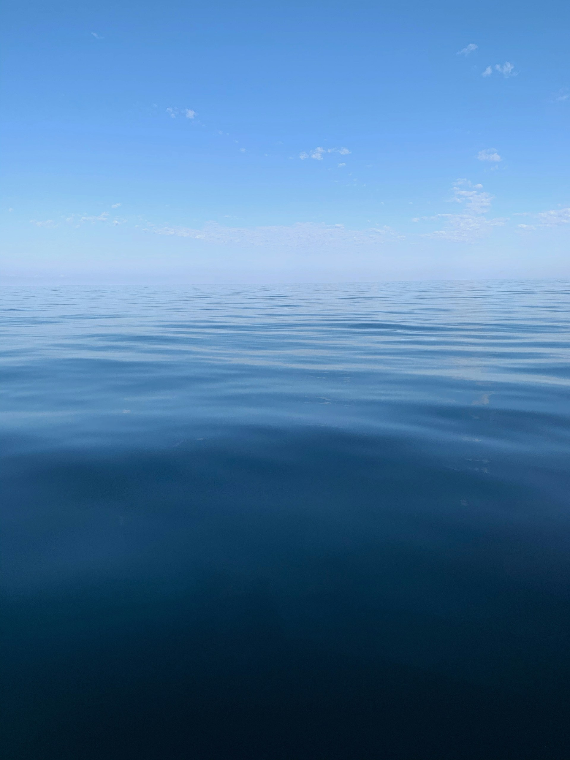 blue body of water under blue sky during daytime