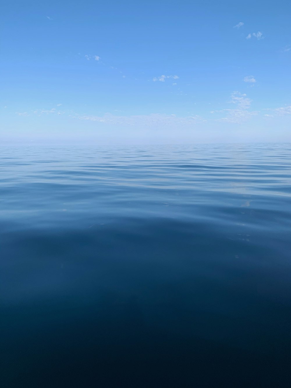 blue body of water under blue sky during daytime