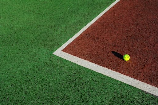 yellow ball on green and white field
