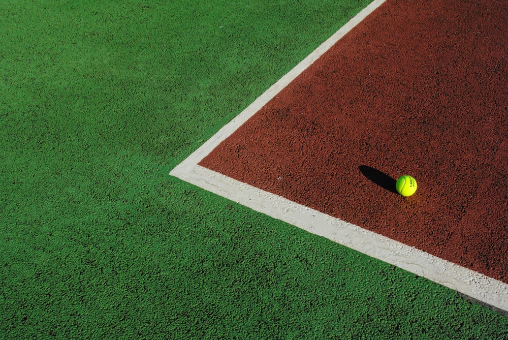 yellow ball on green and white field