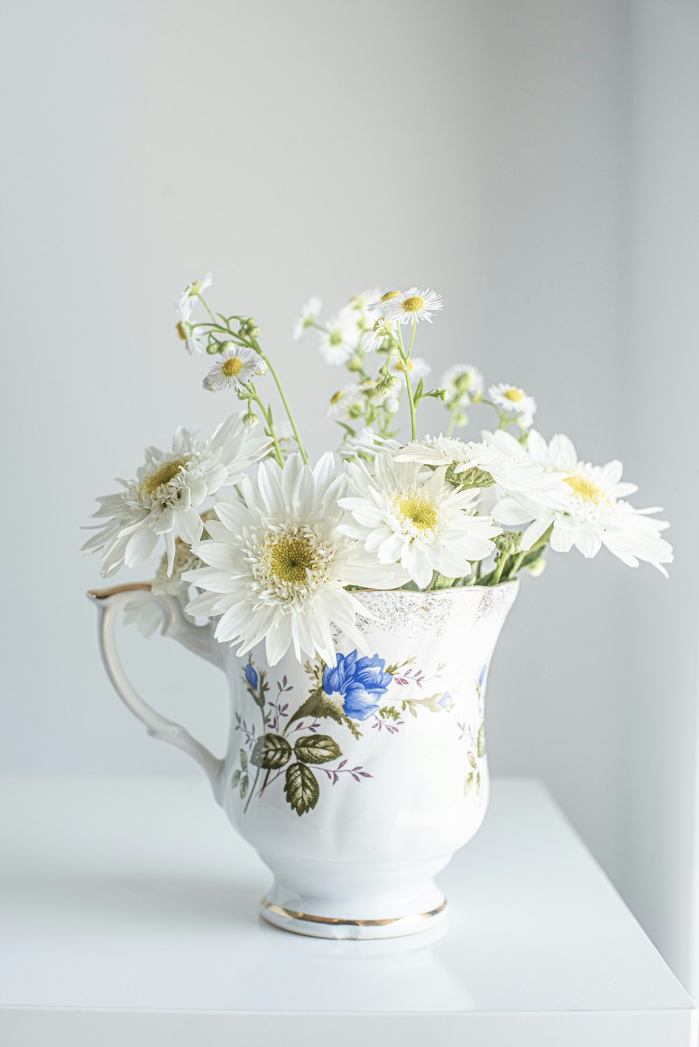 white and blue floral ceramic vase