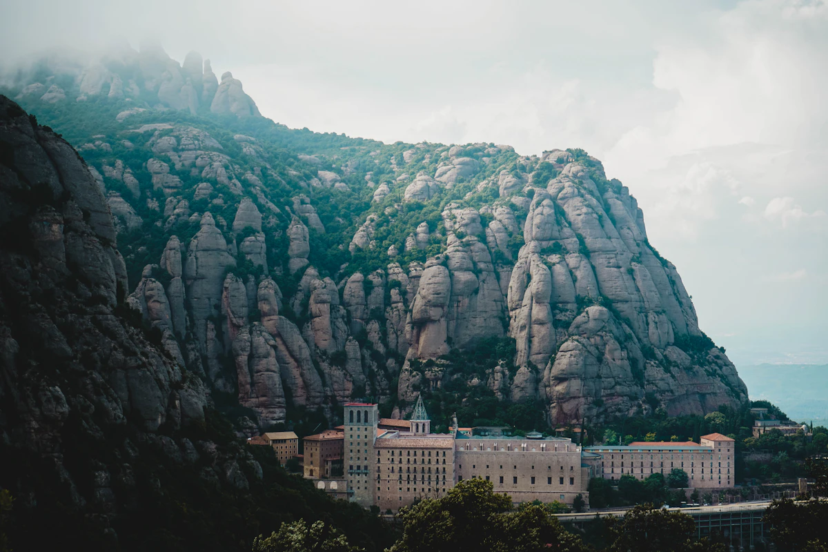 The Montserrat monastery buildings beneath the grey rock towers