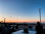 A scenic view of a coastal restaurant at sunset.