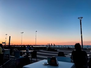 A scenic view of a coastal restaurant at sunset.