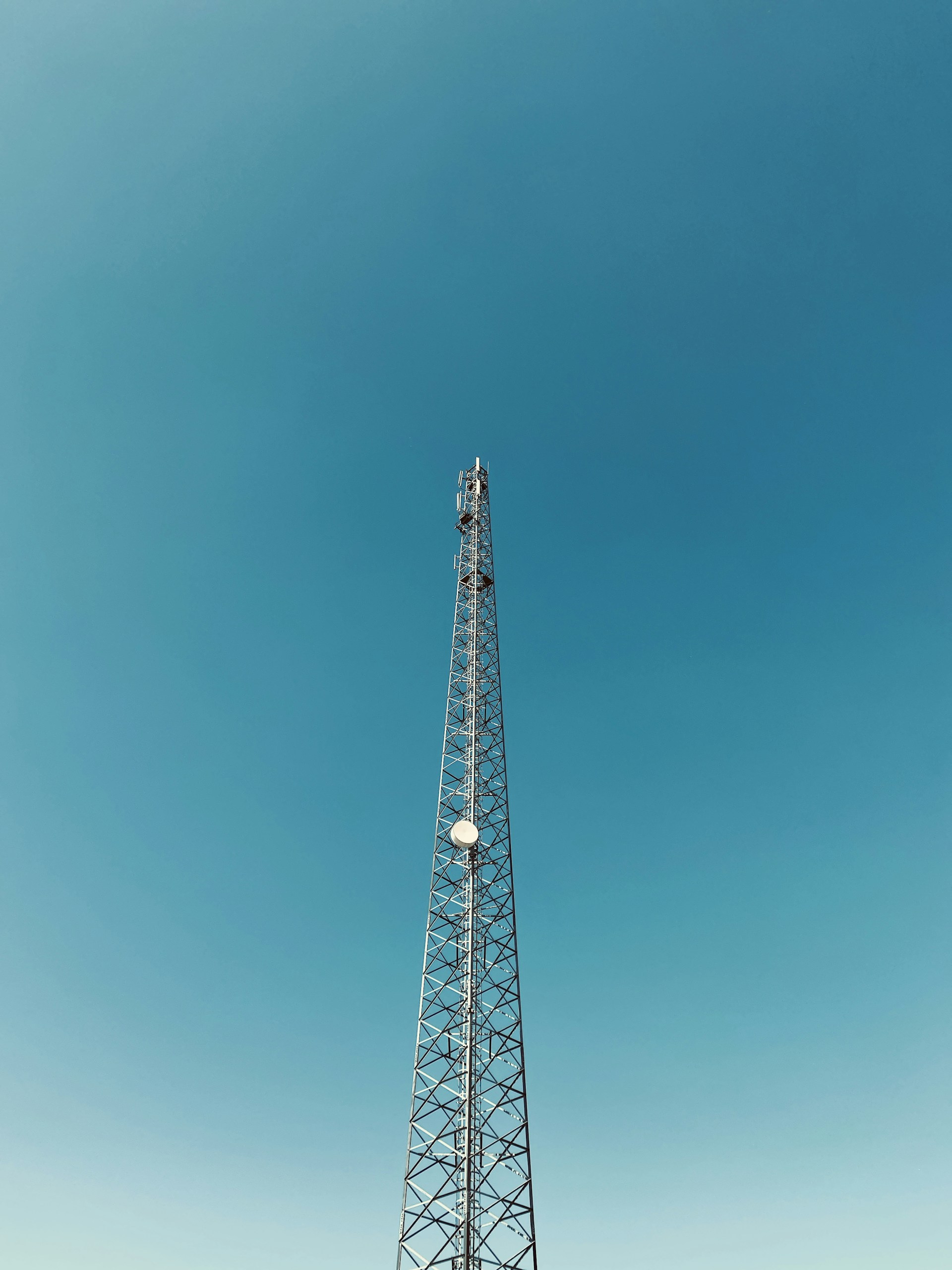 red metal tower under blue sky