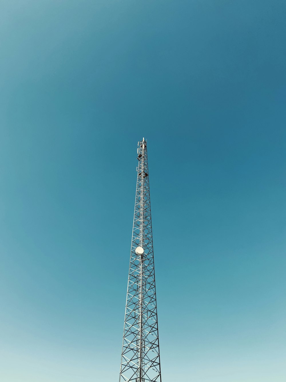 red metal tower under blue sky