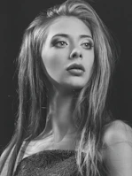 Elegant portrait of a woman with delicate features and warm lighting.