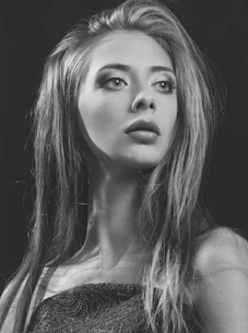 An elegant digital portrait of a professional woman with a poised expression, illuminated by soft, warm lighting.