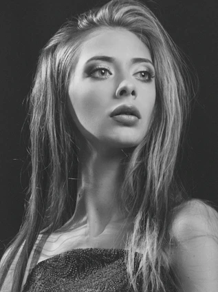 Elegant portrait of a confident woman in soft, light tones reflecting professionalism and warmth.