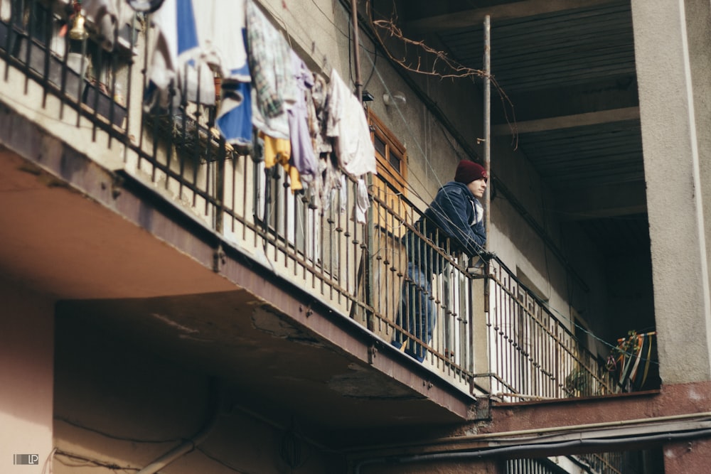 man in black jacket standing on the stairs