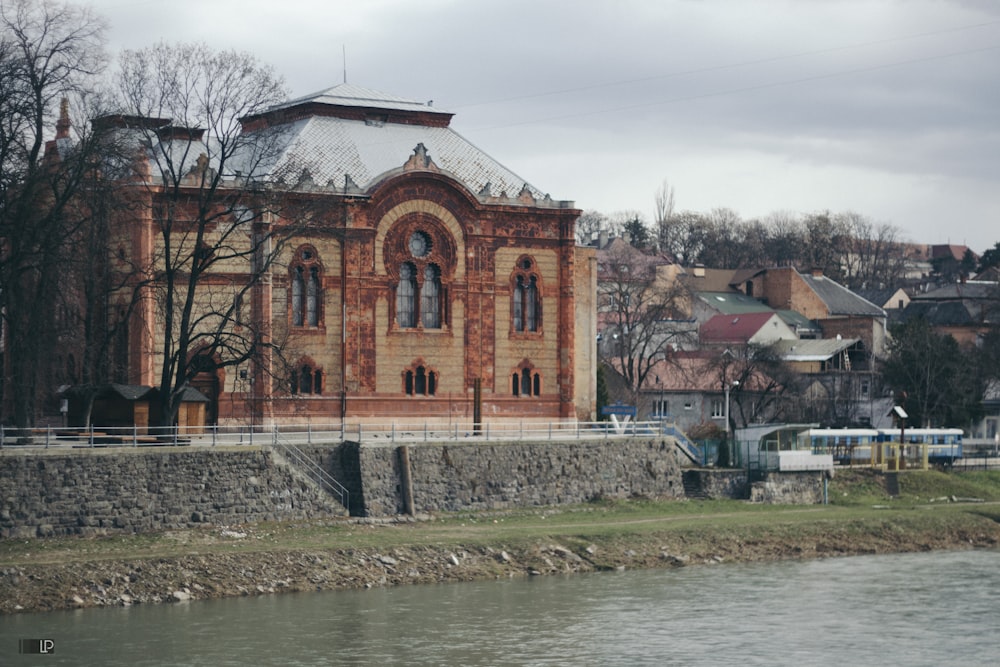 brown concrete building near body of water during daytime