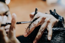 person holding pen and writing on paper