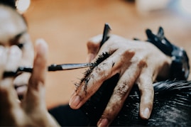 person holding pen and writing on paper