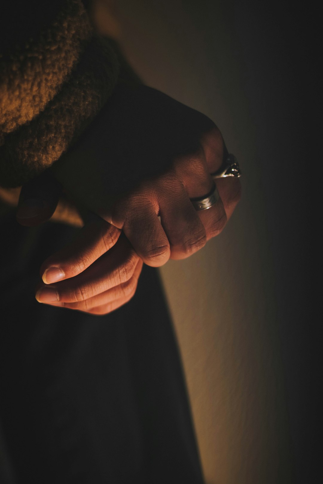 person wearing silver ring and gold ring