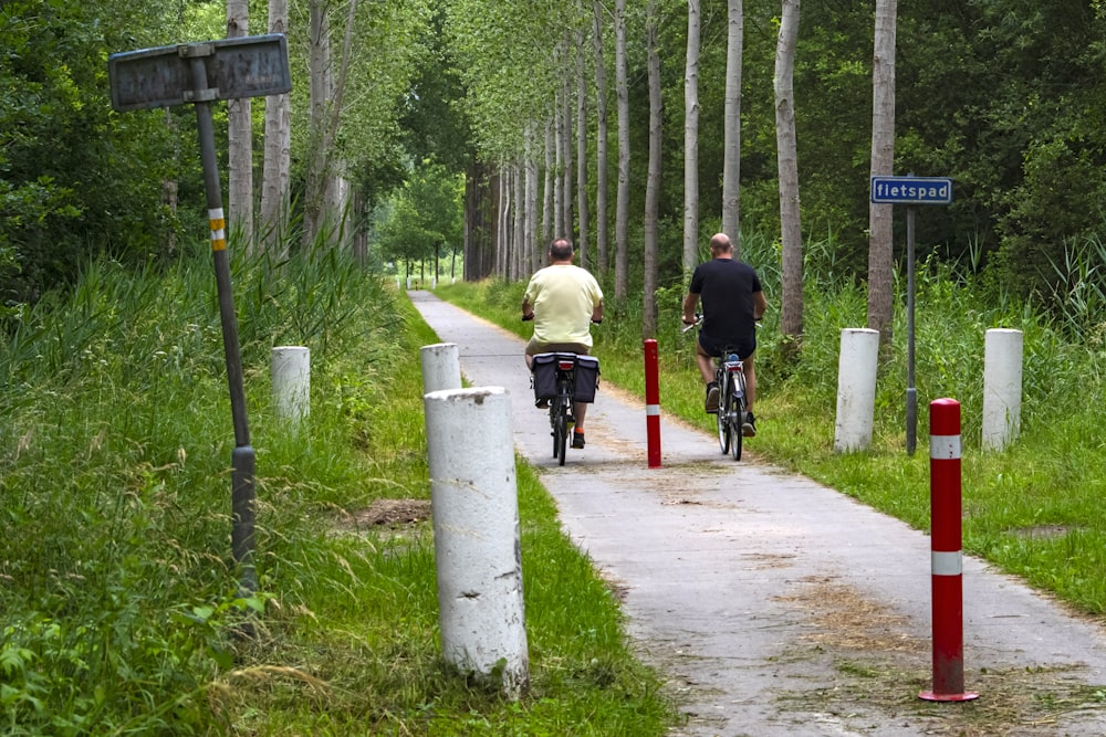 man in black jacket riding bicycle on road during daytime