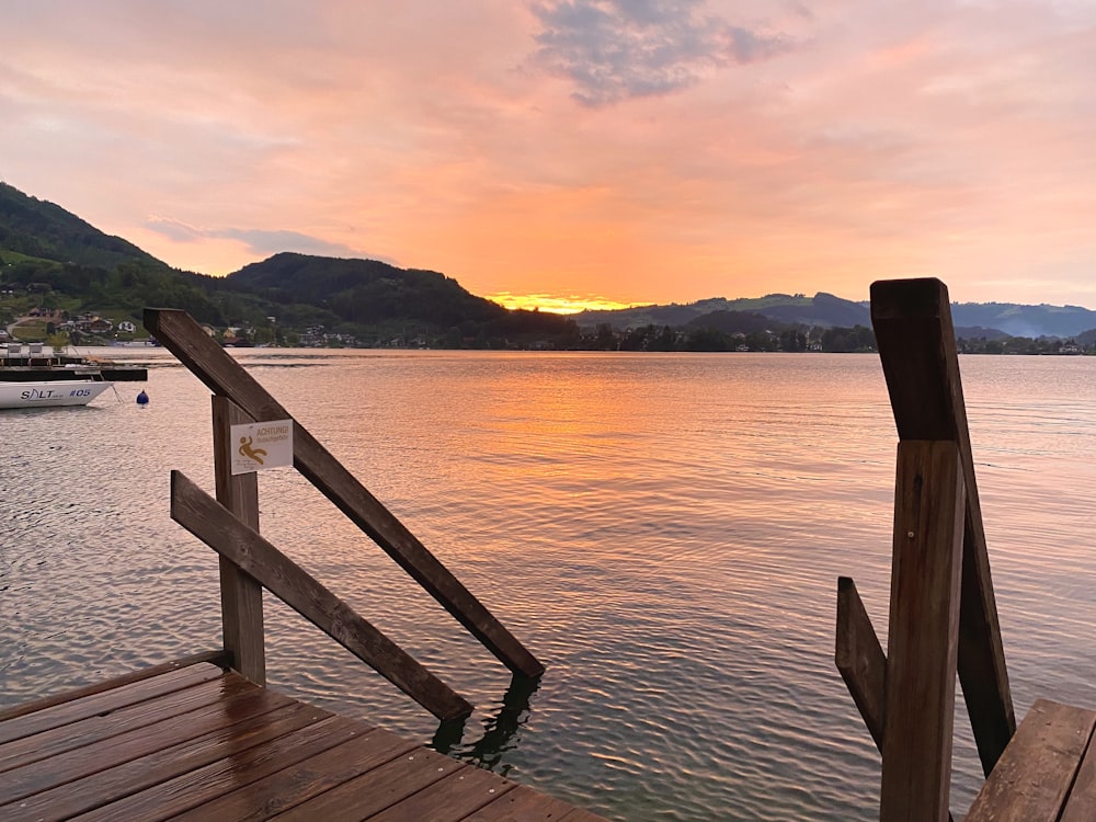 brown wooden dock on body of water during daytime