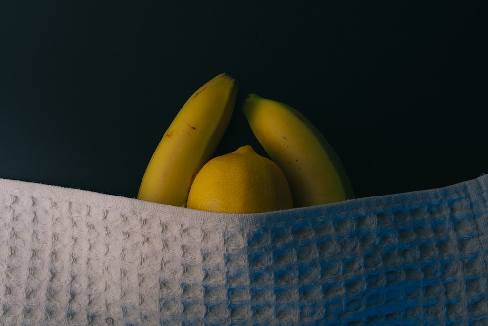 yellow banana fruit on blue textile