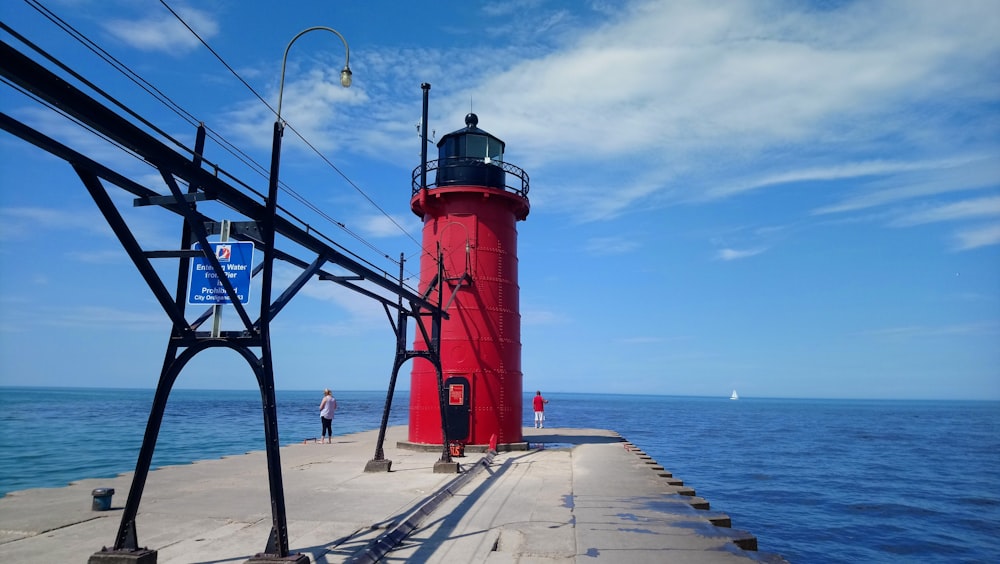 red and white lighthouse near sea during daytime