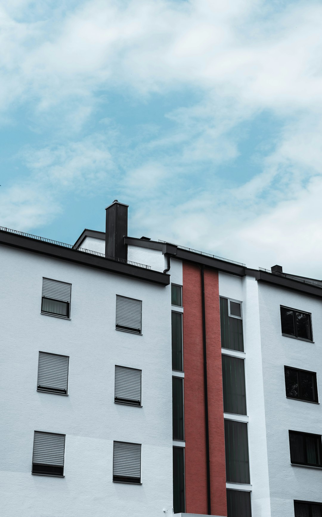 white and red concrete building under blue sky during daytime