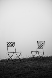 black and white folding chair on green grass field