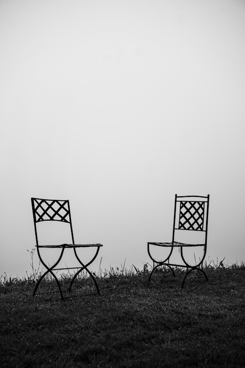 black and white folding chair on green grass field