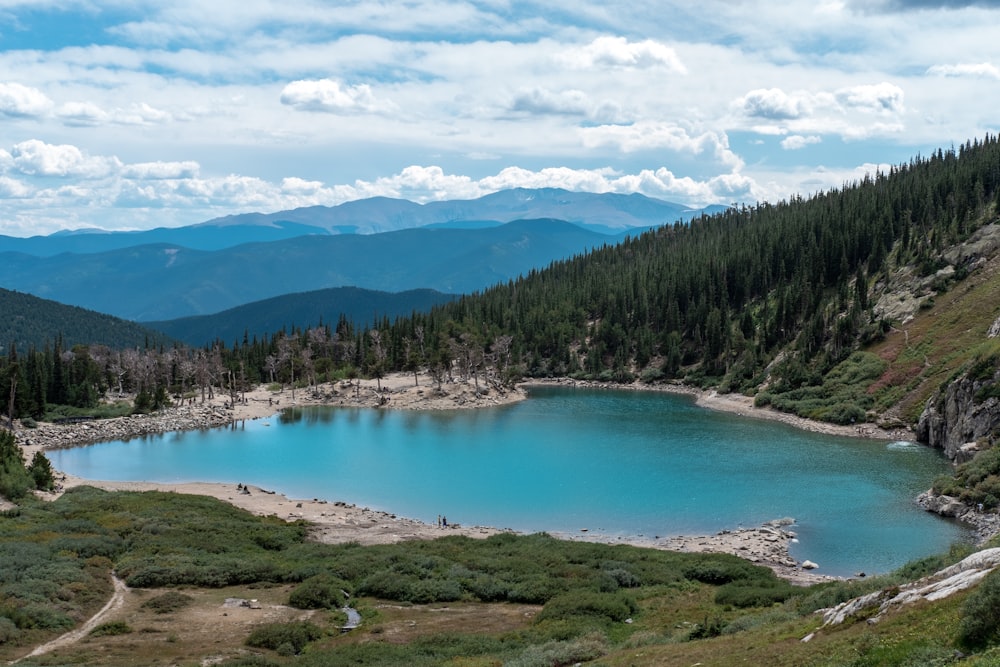 a blue lake surrounded by mountains and trees