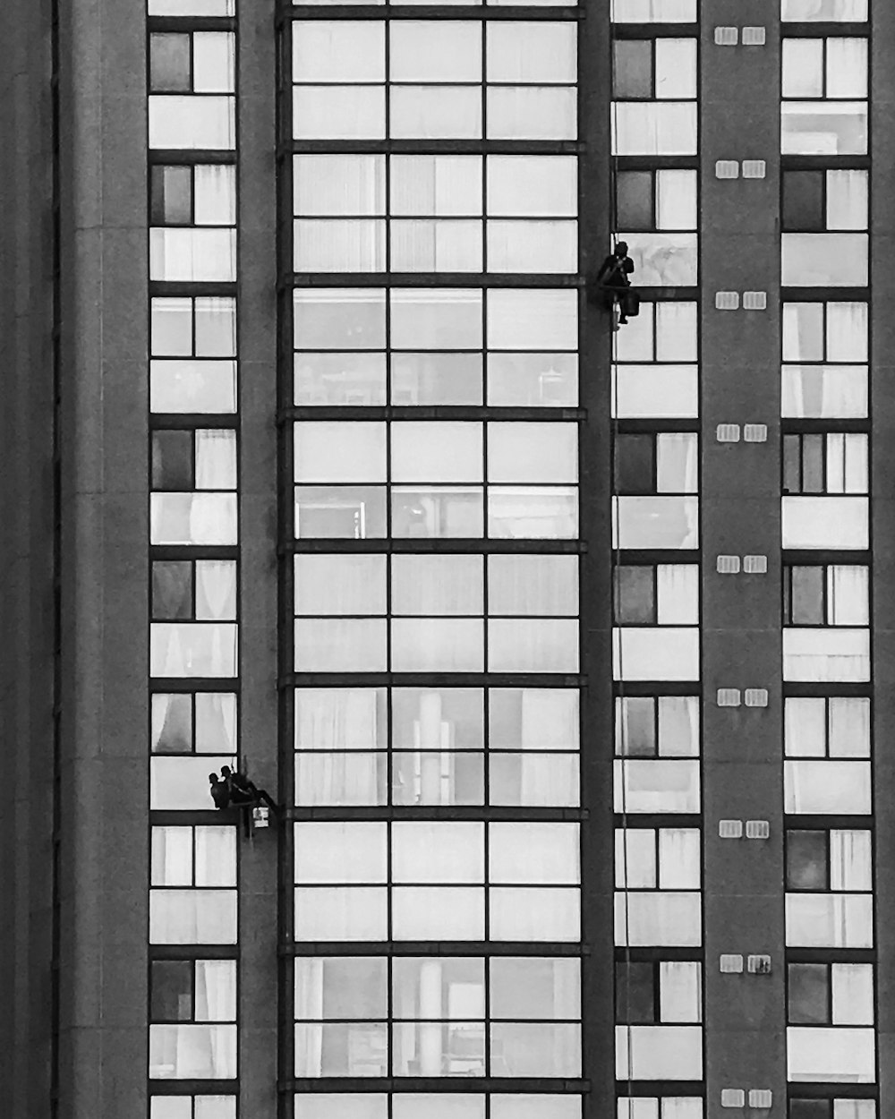 black and white photo of a man in a window