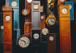 A cozy living room wall adorned with a variety of stylish wall clocks from Chronovista.