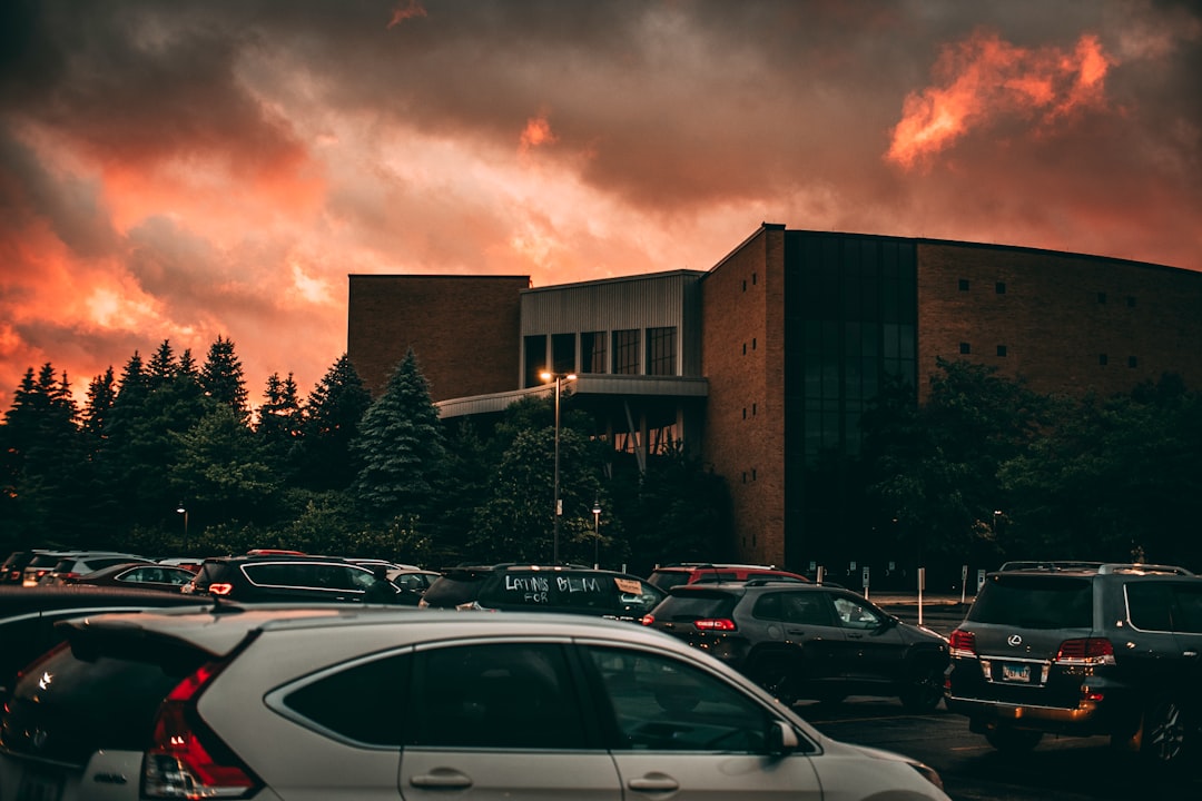 cars parked in front of brown building during daytime